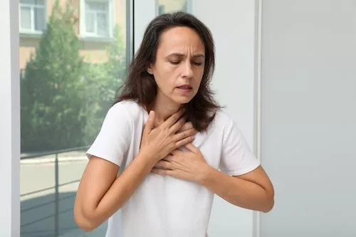 Woman with breathing problems at the window